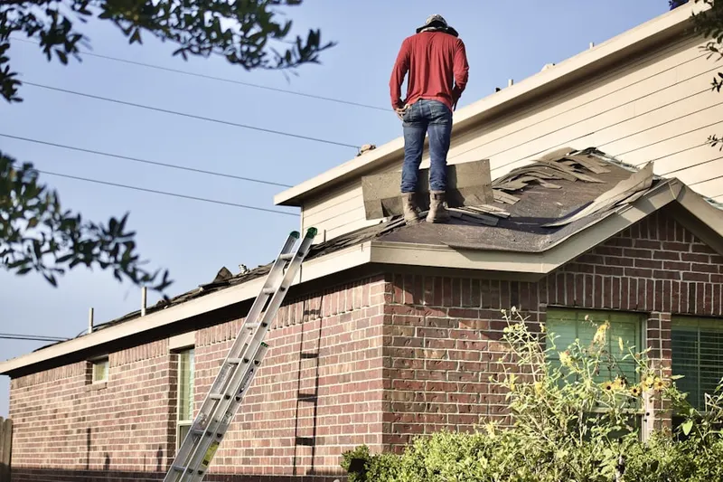 Professional roofer working on a residential roof in Harbor Island